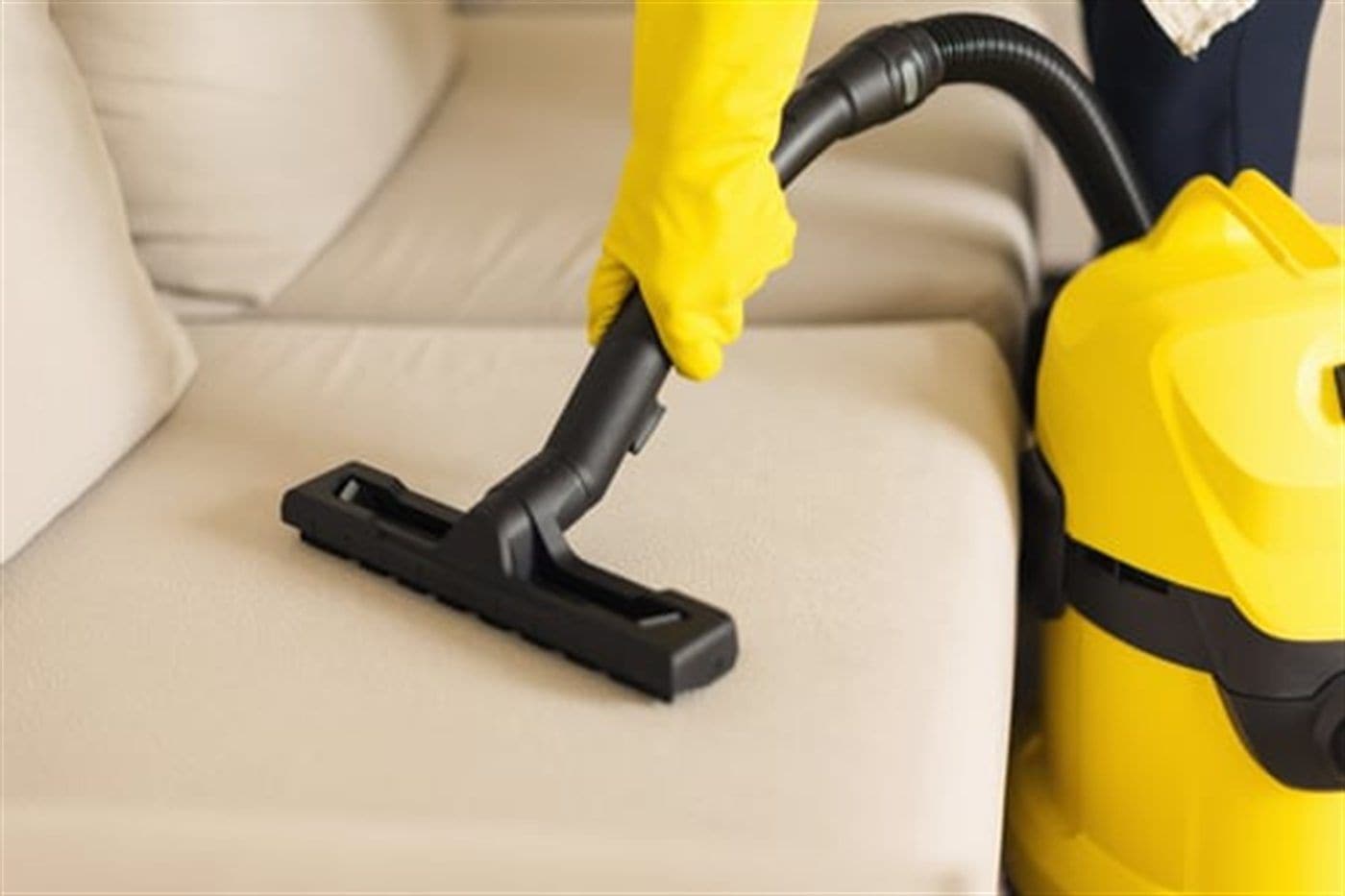 Pereiras Cleaning Service technician steam cleaning a carpet in a Long Island home
