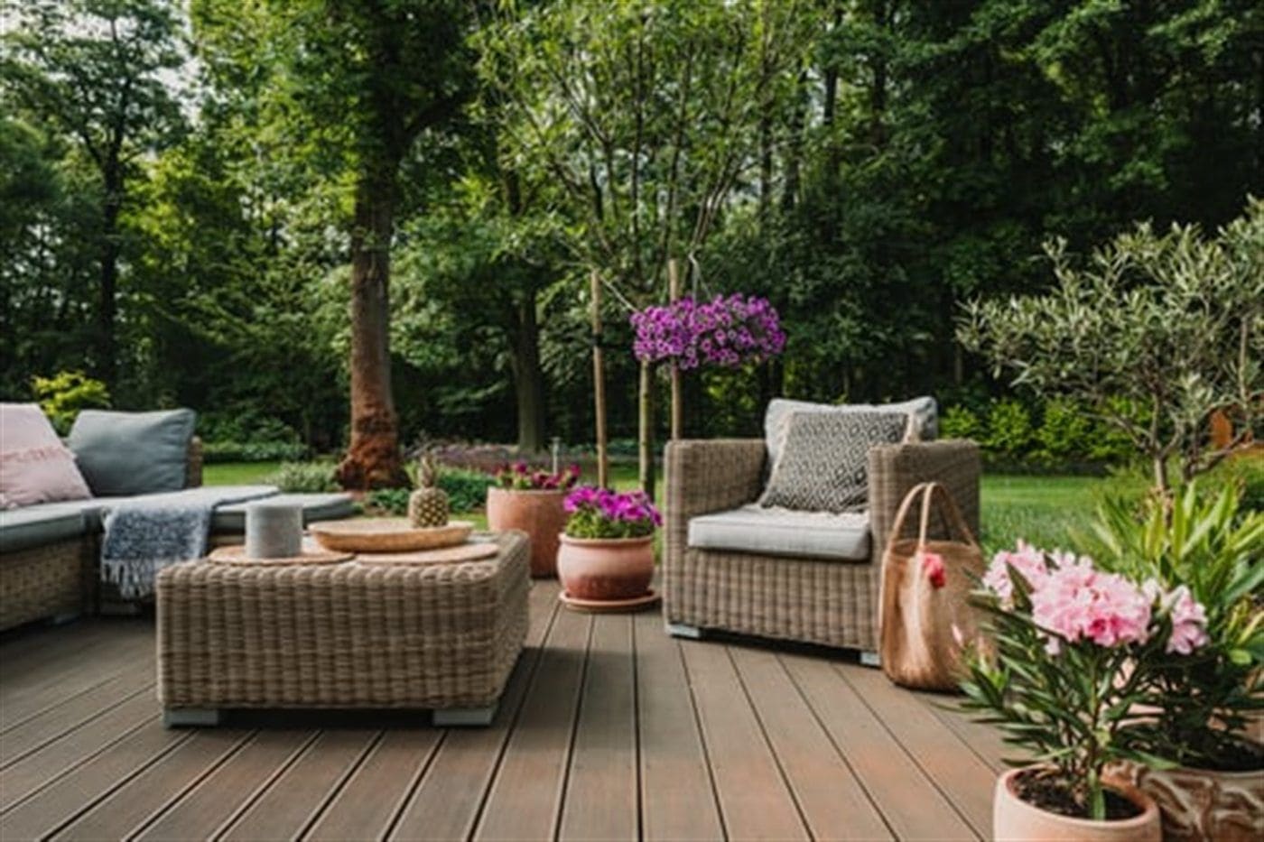 Clean wooden deck with outdoor furniture and planters in a landscaped Long Island backyard
