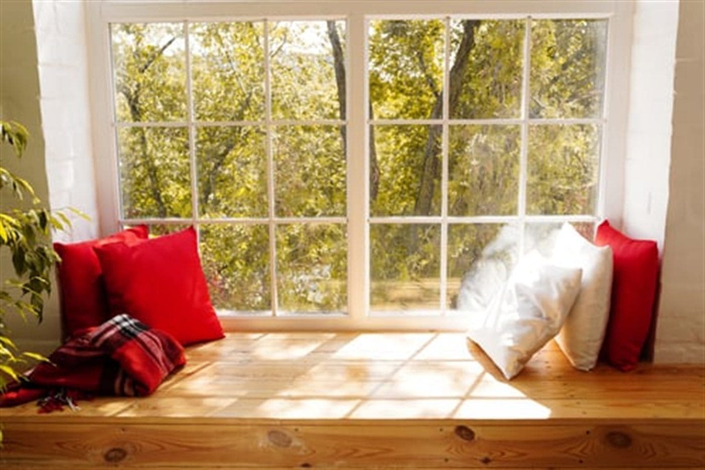 Bright living room window with long fabric curtains and natural light streaming through