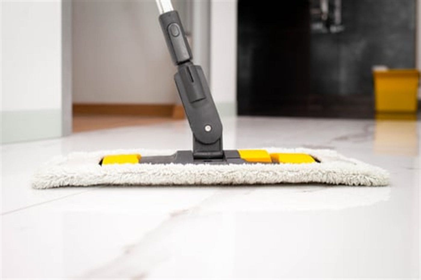 Steam floor cleaner passing over a polished tile floor, leaving a clean streak-free finish